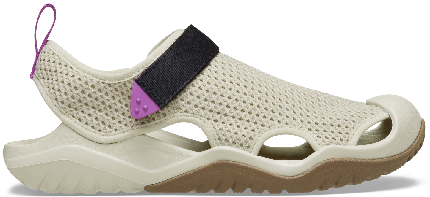 A pair of beige and purple Crocs Swiftwater mesh deck sandals with a hook-and-loop closure.