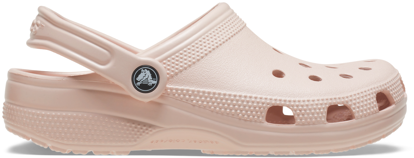 A pair of beige Crocs Classic Clogs with perforations and a pivoting heel strap.