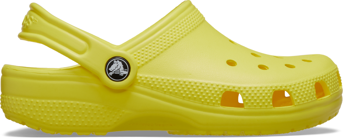 A single yellow toddler clog with a pivoting heel strap and multiple holes on the upper part.