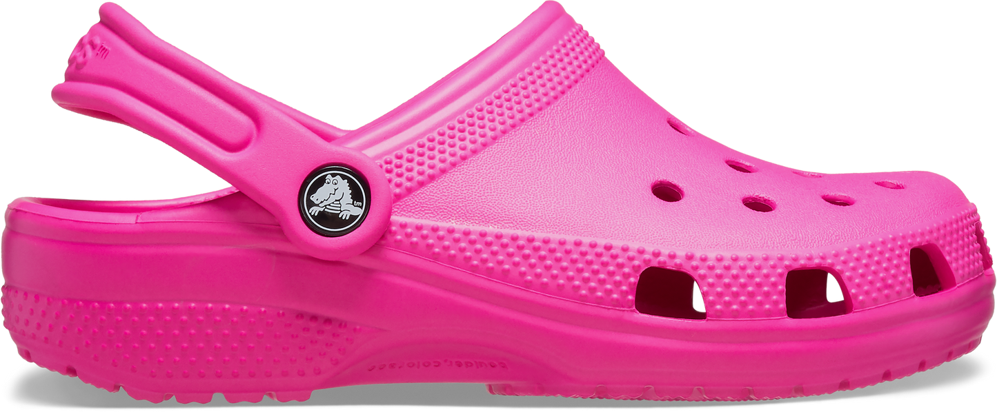 A pink toddler-sized clog with a closed heel and multiple ventilation holes.