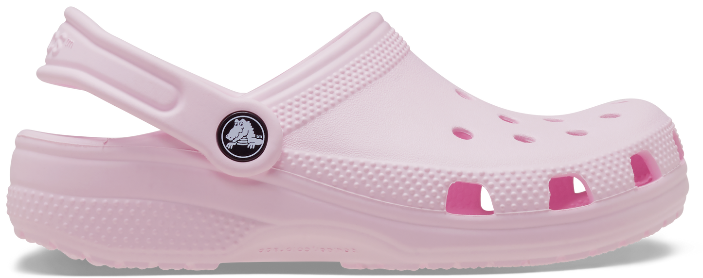 A pink Crocs Classic Clog for toddlers with a secure strap and perforated design for breathability.