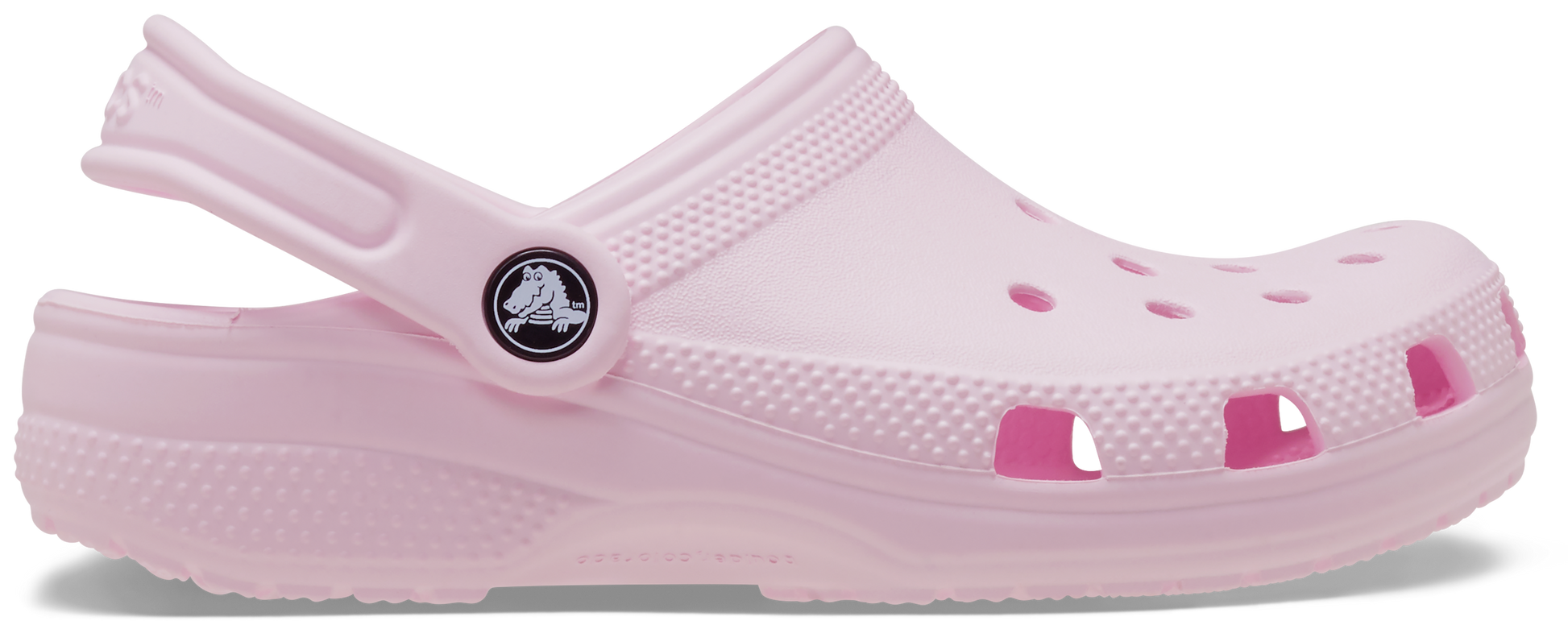 A pink Crocs Classic Clog for toddlers with a secure strap and perforated design for breathability.